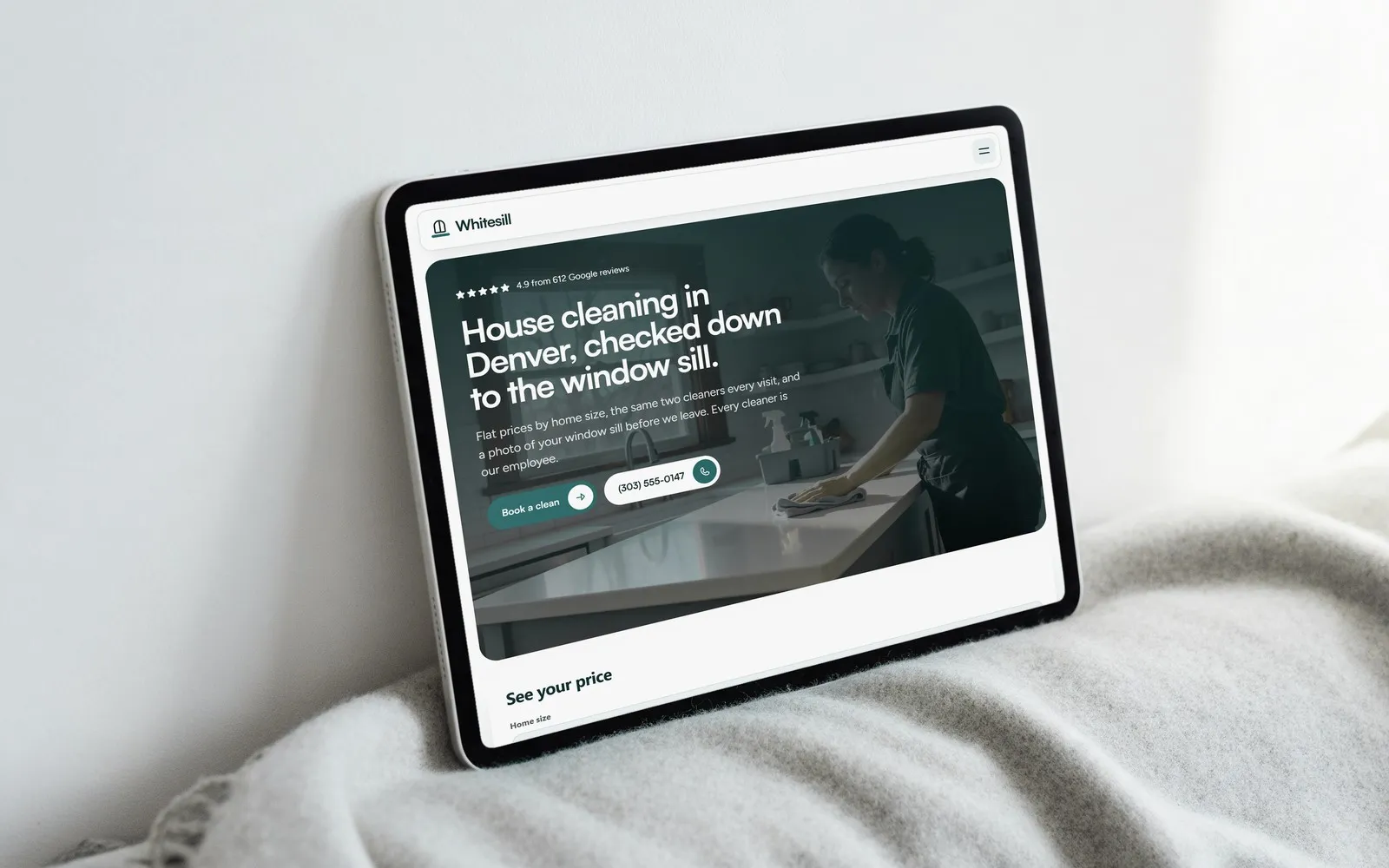 A tablet leaning on a wool blanket, showing the Whitesill home page with its price estimator